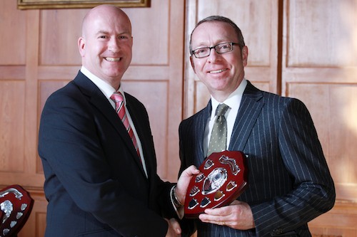 Geoff Clarke, Regional Chairman of the Personal Finance Society (PFS) presents the award to Kevin Curran at a ceremony in the Great Hall at Queens University